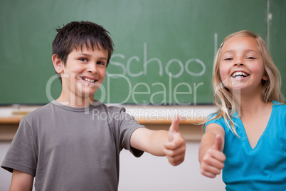 Happy pupils posing with the thumb up