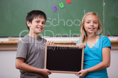 Pupils holding a school slate