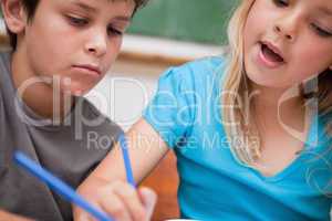 Close up of two children writing