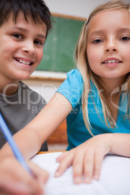 Portrait of two children writing
