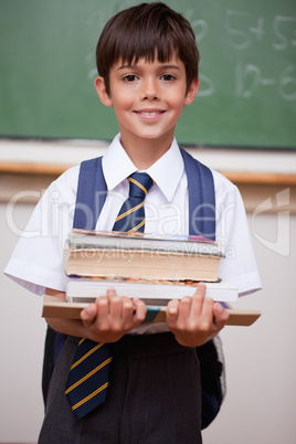 Portrait of a schoolboy holding books