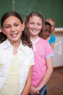 Portrait of classmates posing in a row