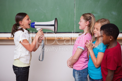 Schoolgirl yelling through a megaphone to her classmates