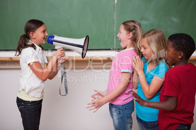 Schoolgirl screaming through a megaphone to her classmates