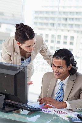 Portrait of a smiling business team studying statistics