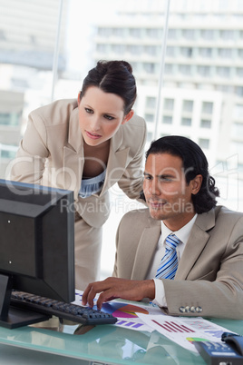 Portrait of a business team studying statistics while using a co