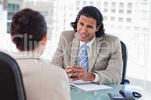 Smiling manager interviewing a female applicant