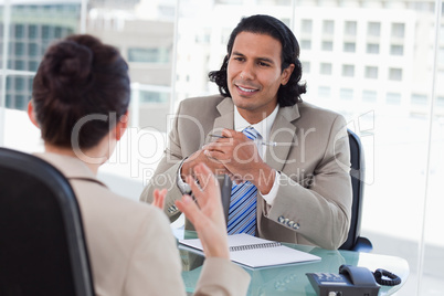 Happy manager interviewing a female applicant