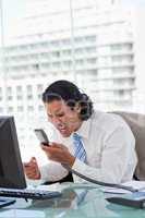 Portrait of a angry businessman shouting at his handset