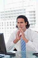 Portrait of a businessman thinking while looking at the camera