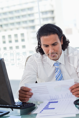 Portrait of a businessman looking at statistics