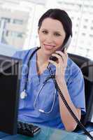 Portrait of a smiling female doctor on the phone