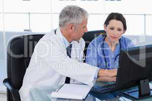 Medical team working together with a computer