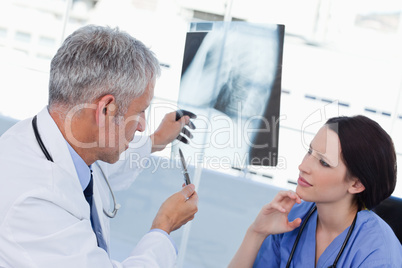 Serious medical team looking at a X-ray