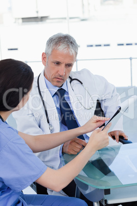 Portrait of a serious medical team looking a document