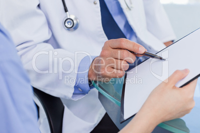 Close up of a medical team looking a document