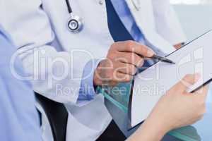 Close up of a medical team looking a document