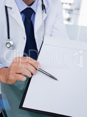 Close up of a male doctor showing a document