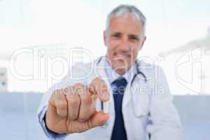 Doctor showing a pill