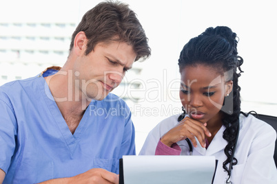 Doctors looking at a document