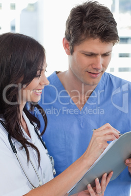 Portrait of smiling doctors looking at a document