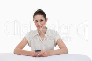 Happy businesswoman writing a text message