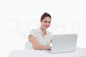 Smiling businesswoman using a notebook