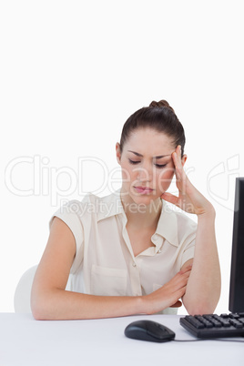 Portrait of a tired secretary using a computer