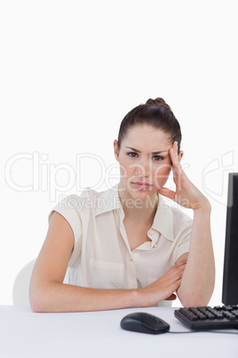 Portrait of a tired businesswoman using a computer