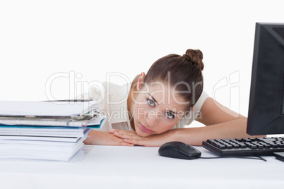 Sad secretary leaning on her desk