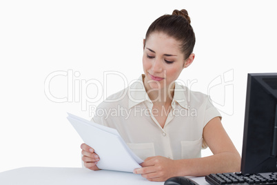 Smiling businesswoman looking a document