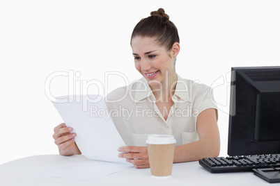 Happy businesswoman looking a document