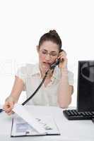 Portrait of a businesswoman making a phone call while looking at