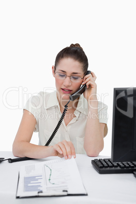 Portrait of a businesswoman making a phone call while looking at