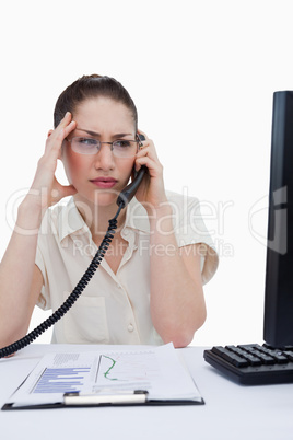 Portrait of a worried manager making a phone call while looking