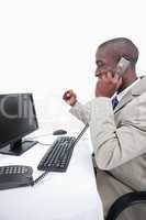 Portrait of a cheerful businessman making a phone call