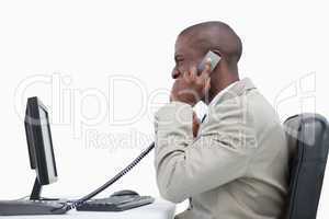 Side view of an angry businessman making a phone call