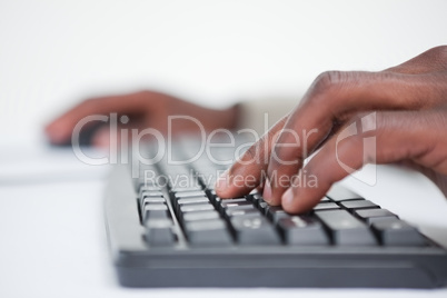 Close up of a masculine hand using a keyboard