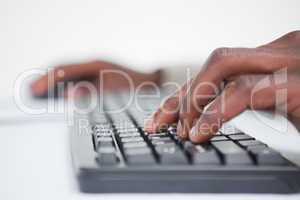 Close up of a masculine hand using a keyboard