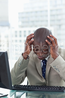 Portrait of a tired office worker using a computer