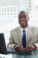 Portrait of a cheerful office worker using a computer