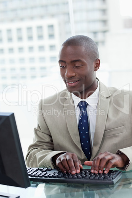 Portrait of a happy office worker using a computer