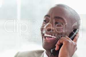 Close up of a laughing businessman on the phone