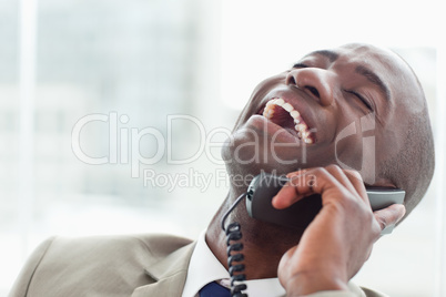Close up of a delighted businessman on the phone