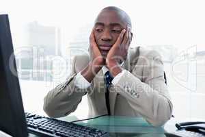 Bored businessman looking at his computer