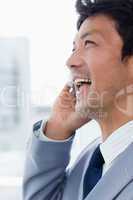 Portrait of a laughing office worker on the phone