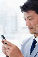 Portrait of an office worker using his mobile phone