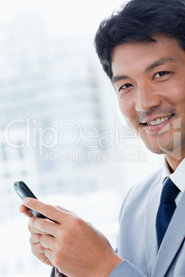 Portrait of a office worker using his mobile phone