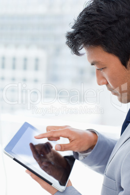 Portrait of a young office worker using a tablet computer