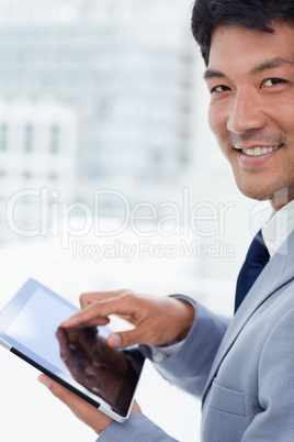 Portrait of a smiling office worker using a tablet computer